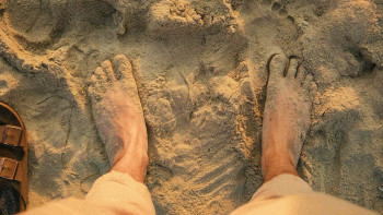 Image of bare feet on the beach